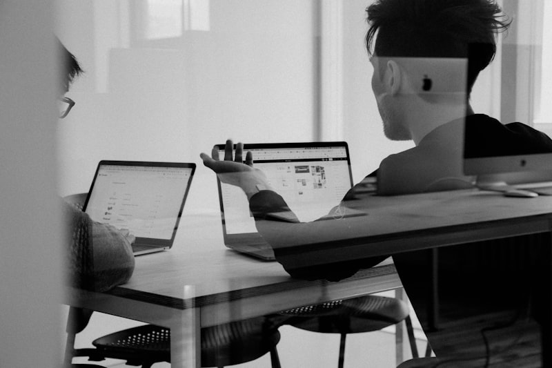 Executive reviewing financial reports on laptop in modern office
